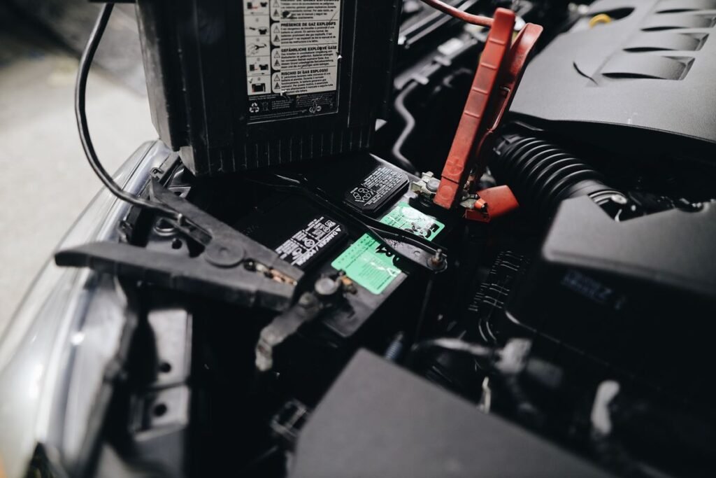 Portable jump starter connected to a car battery