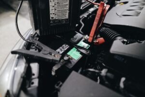 Portable jump starter connected to a car battery